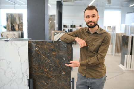 Male customer choosing kitchen ceramic tile in store.の写真素材