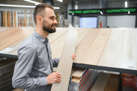 man choosing laminate samples in hardware store.の写真素材