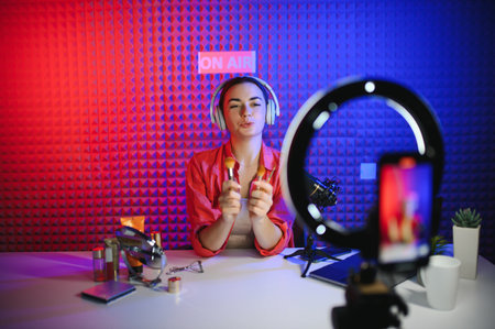 Young creative woman live streaming a video for her followers on social media.の写真素材