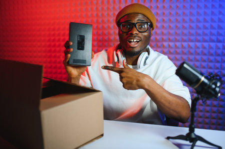 Black male influencer creates material for his internet audience, discussing new trends.の写真素材