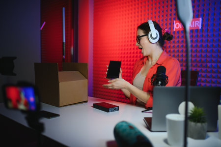 Young creative woman live streaming a video for her followers on social media.