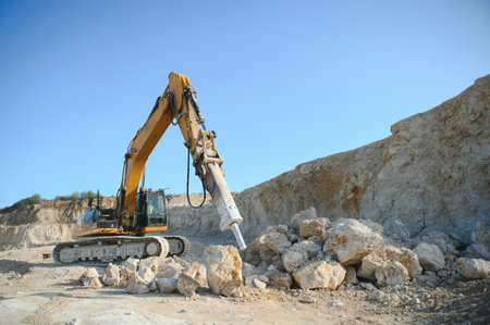 Excavator with hydraulic hammer on road construction works.の写真素材
