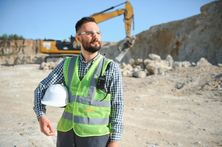 Extraction of stone. Male worker next to stone quarry. Engineer at construction site.の写真素材