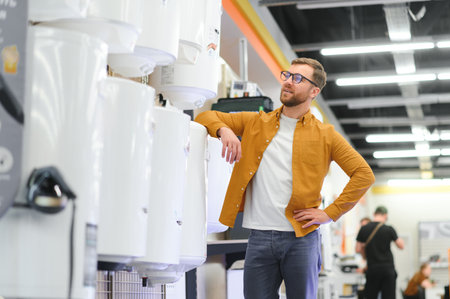 Smiling male customer looking at domestic boilers.の写真素材