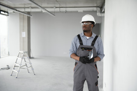 African American engineer at work on construction site.