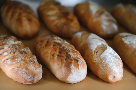 Round bread close-up. Freshly baked sourdough bread with a golden crust on bakery shelves. Baker...