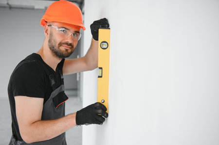 Construction Worker in uniform with spirit level.
