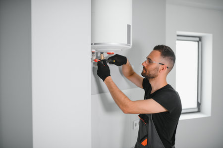 Professional plumber servicing a boiler.
