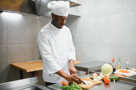 handsome African American chef at restaurant kitchen.