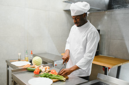 handsome African American chef at restaurant kitchen.