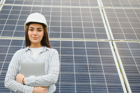 Woman engineer in helmet on construction site of solar power plant. Agreement concept.の写真素材