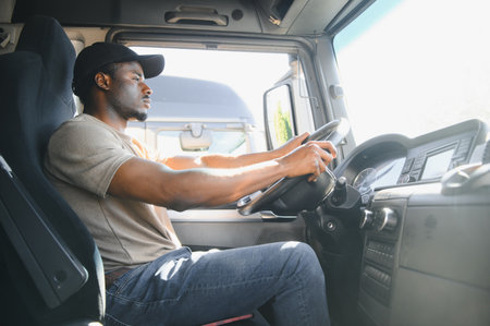 Professional driver sitting in truck cabin and driving.の写真素材