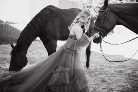 young woman in a dress with a horse.の写真素材
