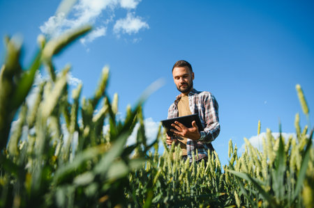 Portrait of farmer standing in wheat field.の写真素材