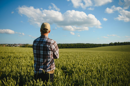 Portrait of farmer standing in wheat field.