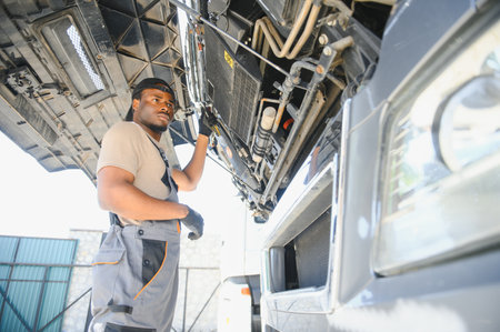 Professional truck mechanic working in vehicle repair service.の写真素材
