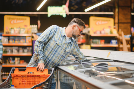 Happy senior man at grocery store products.の写真素材