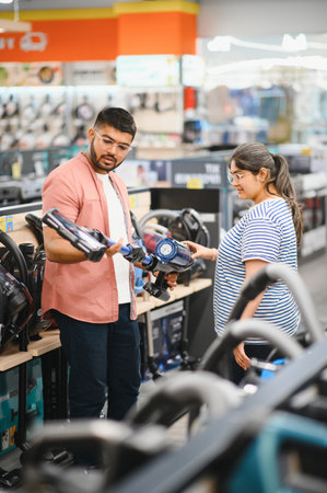 Couple choosing vacuum cleaner, electronics storeの写真素材