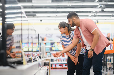 Couple in shopping. They are looking for a new tv.の写真素材