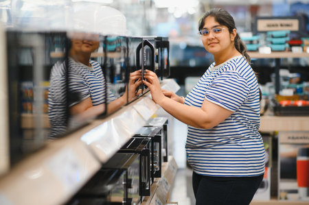 Woman shopping for microwave in appliances store.の写真素材