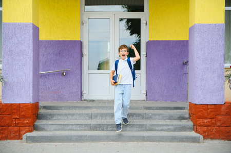 schoolboy runs out of school.の写真素材