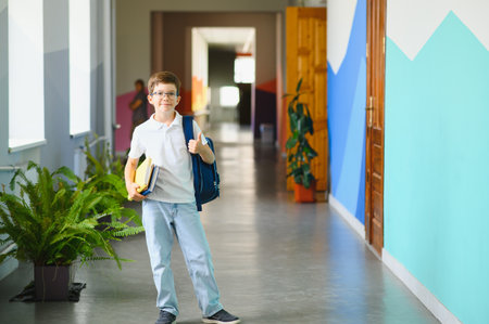 Portrait confident schoolboy in school corridor.の写真素材
