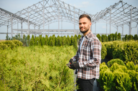 Caucasian man choosing sprouts in garden center.の写真素材