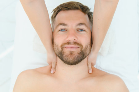 Young man having a massage by a professional masseuse.の写真素材