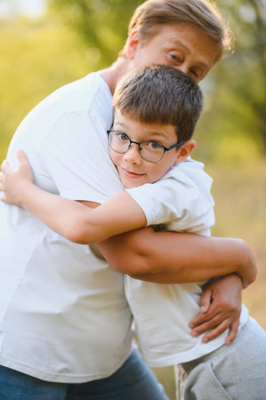 Grandmother and her little grandchild together in sunny summer park.の写真素材