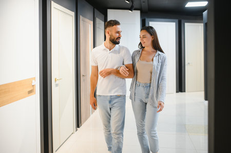 A young couple chooses interior doors for their new homeの写真素材