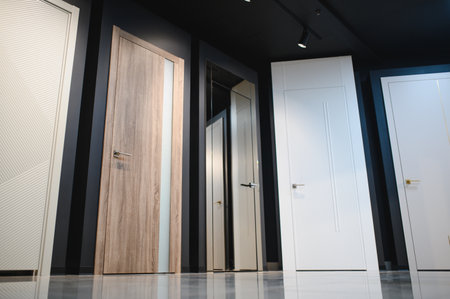 The samples of various wooden doors in the exhibition area of a store.の写真素材