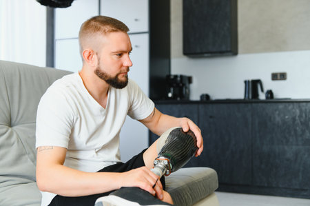 Portrait of man with prosthetic leg at home, copy space.の写真素材