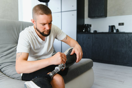 portrait of man with prosthetic leg sitting.
