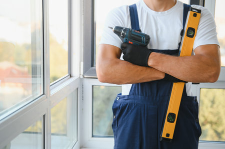Construction worker installing window in house.の写真素材