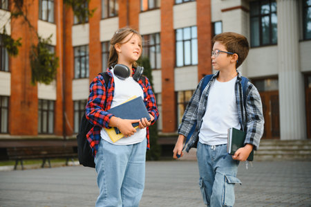 Happy children near the school. Friends boy and girl together in the school yard.の写真素材