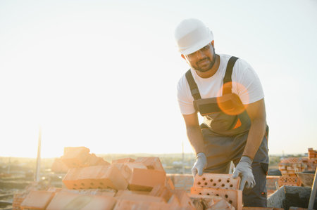 Indian Construction worker in uniform and safety equipment have job on building.の写真素材