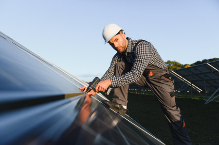 Worker installing solar panels outdoors.