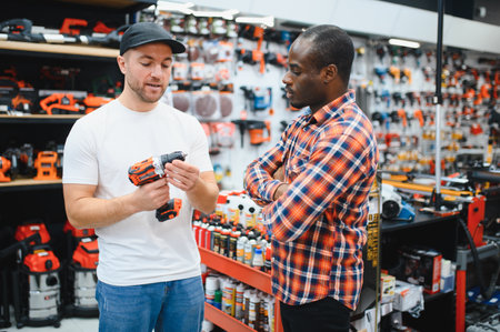 The seller helps the buyer choose a screwdriver in a hardware store