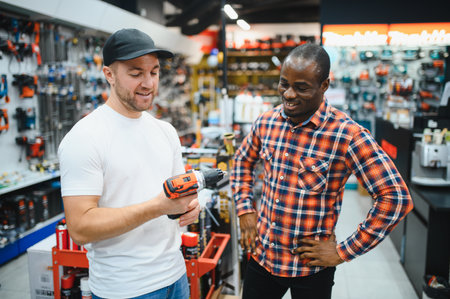 The seller helps the buyer choose a screwdriver in a hardware storeの写真素材