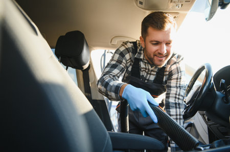Feeling happy to be doing an excellent job at my job at the car wash. Portrait of a man while sitting inside a customer vehicle.の写真素材
