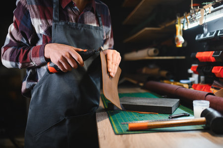 Banner tailor industry craftsman. Leather rolls and tools for handmade craft in workshop.の写真素材