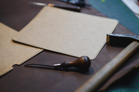 Crafting tools on natural cow leather in the tailoring workshop. Top view.の写真素材