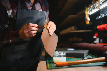 Banner tailor industry craftsman. Leather rolls and tools for handmade craft in workshop.の写真素材