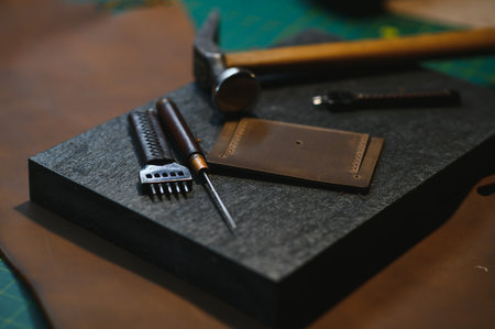 Tools for leather craft on leather backgroung.の写真素材