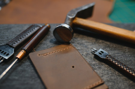 Crafting tools on natural cow leather in the tailoring workshop. Top view.の写真素材