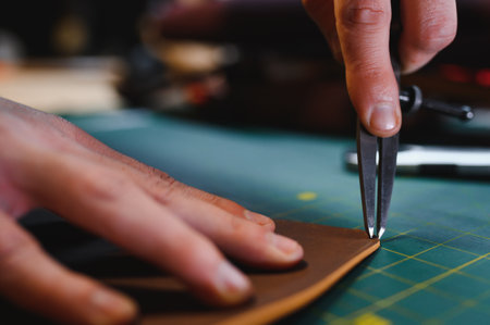 work in leather shop on dark background.
