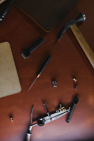 Tools for leather craft on leather backgroung.の写真素材