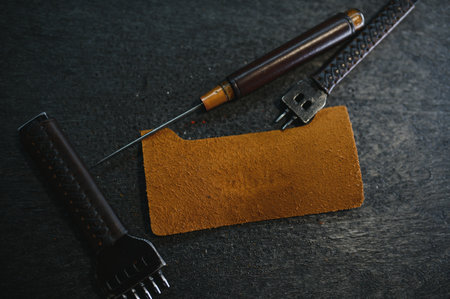 Tools for leather craft on leather backgroung.