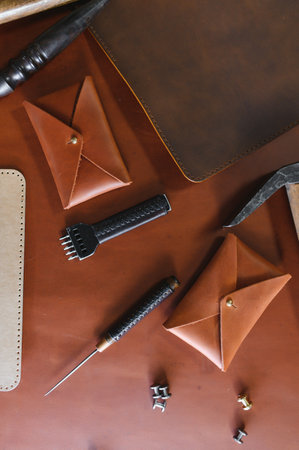 Tools for leather craft on leather backgroung.