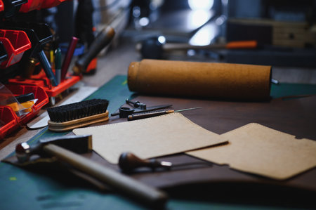 Crafting tools on natural cow leather in the tailoring workshop. Top view.